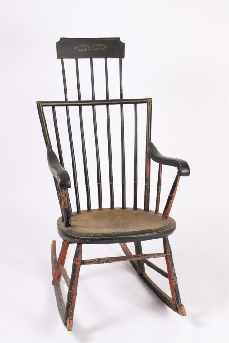 (19th c) COMB BACK WINDSOR ROCKER: Paint decorated with contrasting black and yellow paint. 41 1/2 x 20 1/2 x 28 inches