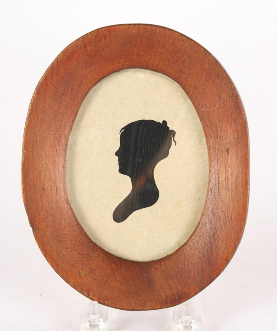 (19th c) HOLLOWCUT SILHOUETTE of a YOUNG GIRL: White cut paper over black cloth. 7 x 5 1/2 inches (overall including frame)