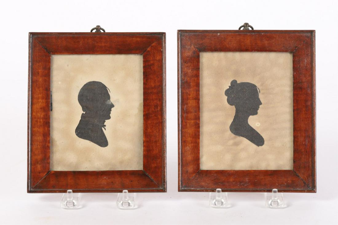 PAIR OF (19th c) HOLLOWCUT SILHOUETTES: "Husband and Wife" cut paper with black cloth ground. 6 1/2 x 5 1/2 inches (including tiger maple frames)