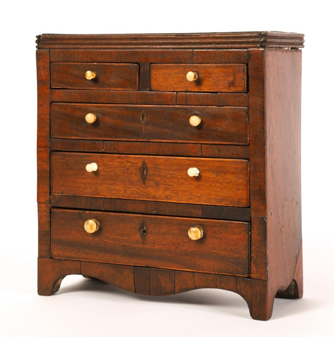 MINIATURE CHIPPENDALE MAHOGANY DRESSER: Molded top, (2) Smaller drawers over (3) graduating drawers with diamond escutcheons, shaped apron and bracket feet. Pine secondary woods. 9 x 8 x 3 1/2 inches