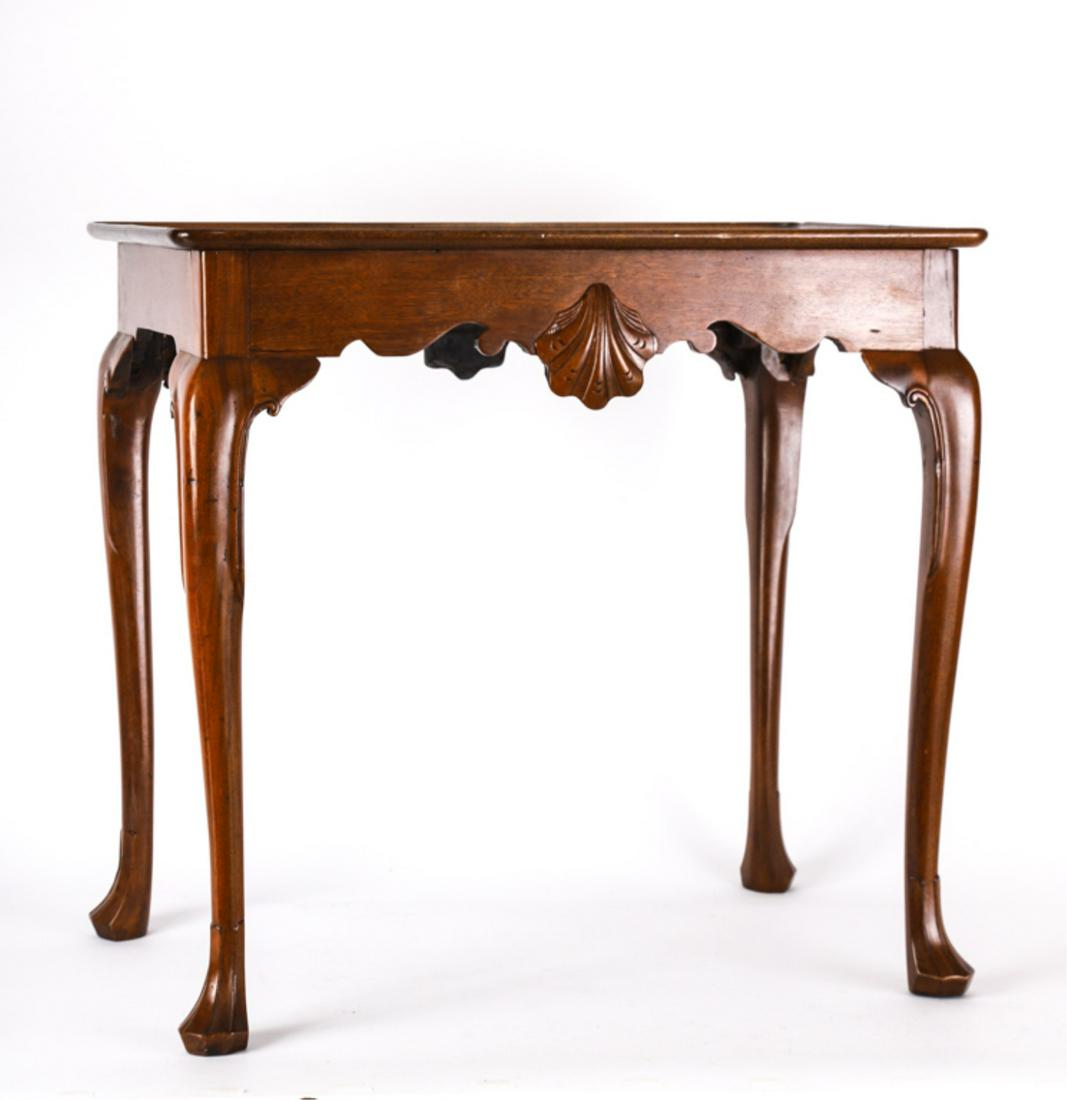 (18th c) CARVED MAHOGANY TRAY-TOP TEA TABLE: Shaped shell carved apron with cabriole legs with returns and interestingly carved feet. 28 x 30 x 19 inches. The auction house believes this piece may be American