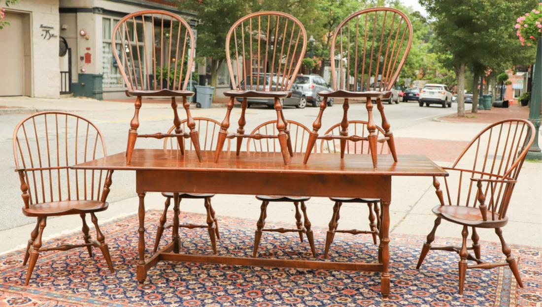 D.R.DIMES FARM TABLE & SET OF (8) WINDSOR CHAIRS: (6) Side and (2) Arm bowback Windsor style dining chairs with formed seats, nicely turned legs and stretchers with pegged construction. Armchairs measure 41 x 24 x 16 inches. Alongside a fine hand pla