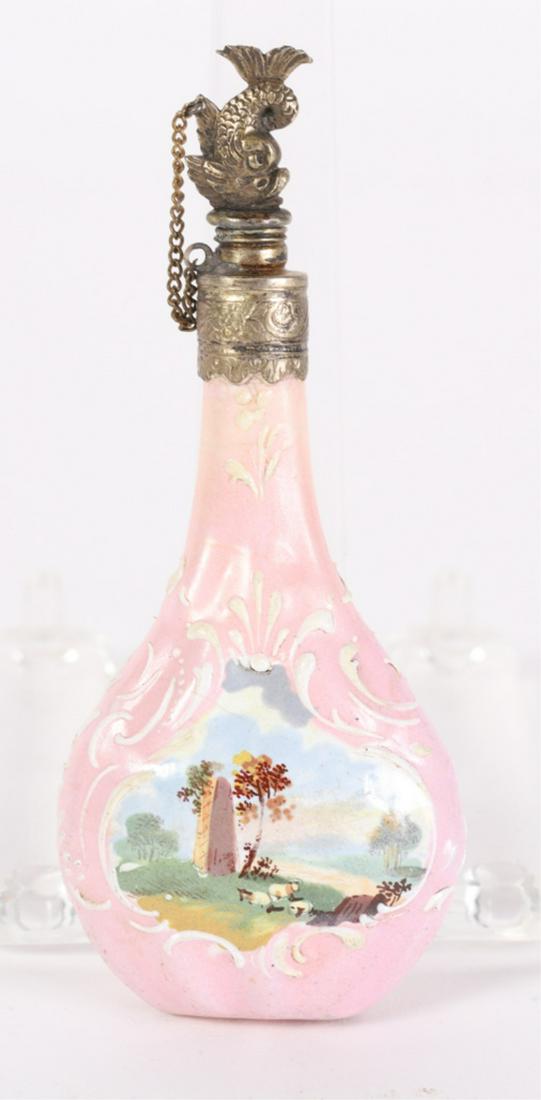(18th c) CHELSEA PORCELAIN PERFUME BOTTLE: Dolphin-form stopper on chain surmounts porcelain flask-form font hand painted with romantic landscapes within cartouches of raised white enamel scrolls. 4 /2 inches