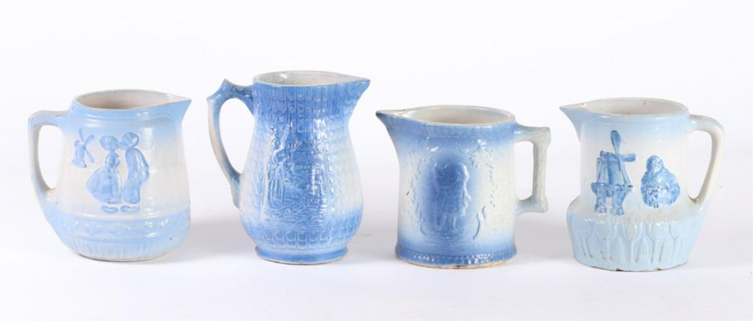 (4) BLUE & WHITE STONEWARE PITCHERS: Including: (2) with Dutch motif, Castle and Hansell and Gretel. 8 inches (and under)