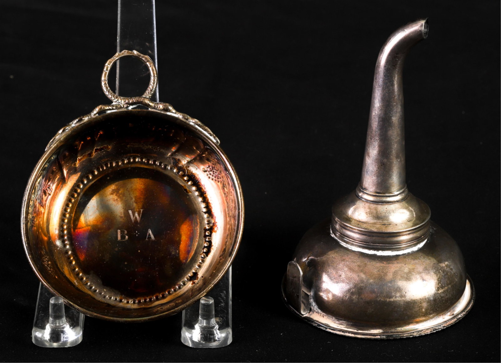 STERLING SILVER WINE FUNNEL and TASTEVIN: Funnel with strainer is signed T.H.. The tastevin is unmarked. 5 inch funnel weighs 3.185 troy ounces