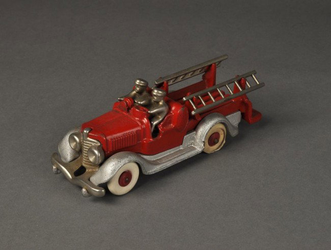 Cast iron Fire truck with two removable ladders and: Cast iron Fire truck with two removable ladders and two men Made in the USA body marked 2171. Height: 3"" Length: 8 1/2""