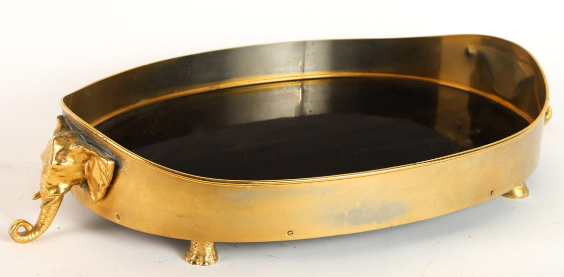MIKA GOLD PLATED ELEPHANT-FORM SERVICE TRAY: Elephant head handles and feet support a rosewood tray. 4 x 25 x 15 inches Condition: Finish / surface cracks, scratches to rosewood.