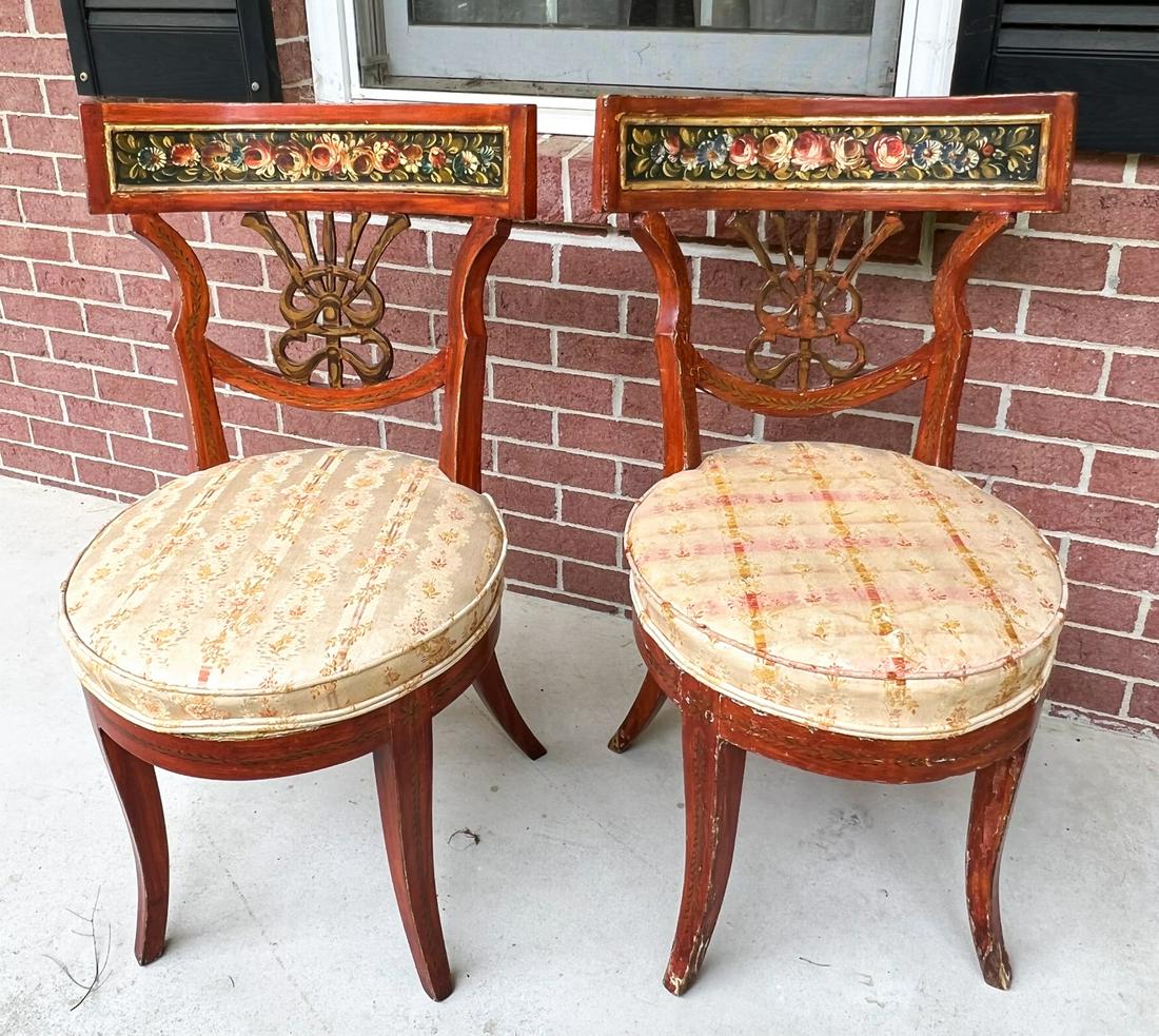 (20th c) DECORATOR QUALITY UPHOLSTERED SIDE CHAIRS: Pair with a country Italian motif with distressed crest rail hand painted with a band of roses over pierced splat, round seat and saber legs. 33 x 18 x 18 inches Condition: Upholstery near back suppor