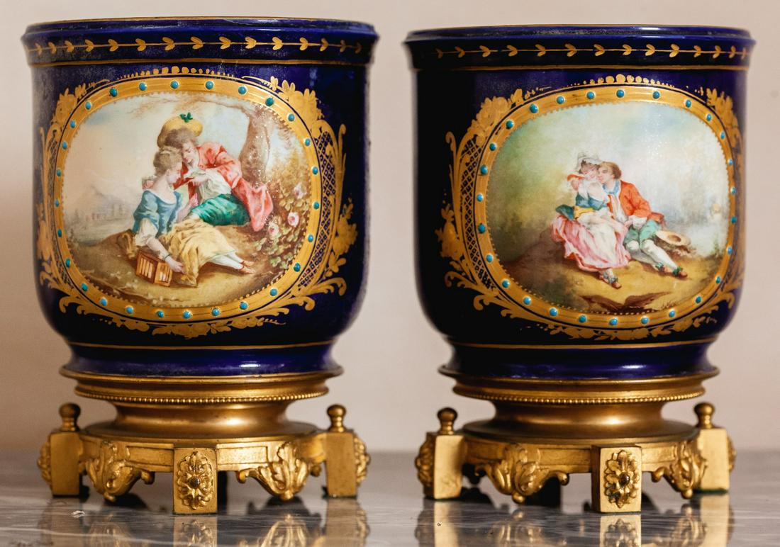 PAIR OF SEVRES QUALITY VASES with ORMOLU BASES: Hand painted with courship scenes and floral bouquets. 6 x 4 1/2 inches Condition: (1) Appears good, the second has been significant signs of repair.Temp No 65