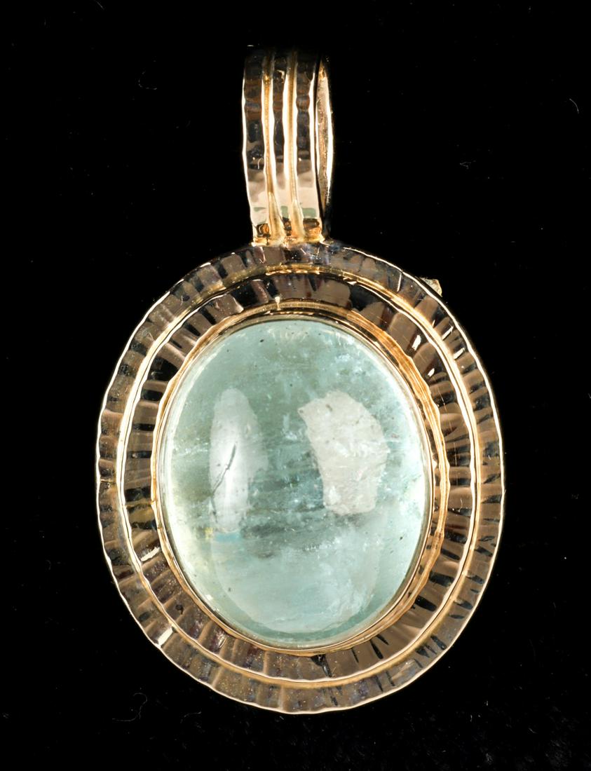 BAKSA 14k GOLD CABOCHON-CUT AQUAMARINE PENDANT: White gold with cabochon-cut oval aquamarine 15.65 ct. 1 inch (not including bail). 5.7 dwt Condition: GoodTemp No 46-9046