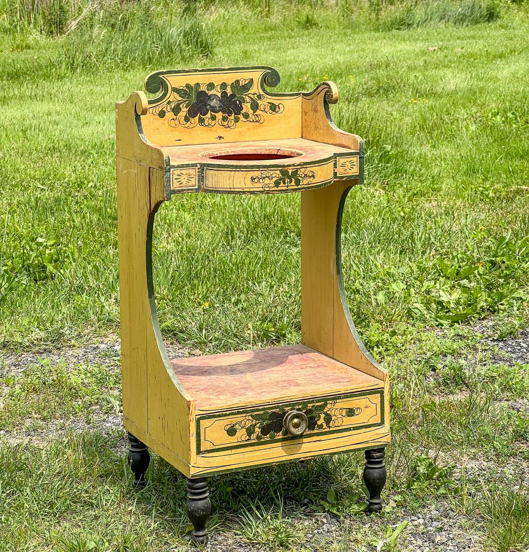 PAINTED STATE OF MAINE FEDERAL WASHSTAND: On turned black painted legs. Grain and floral painted decoration. Nice green borders. 37 x 18 x 16 1/2 inches. Condition: Age related separations. Expected wear to paint.