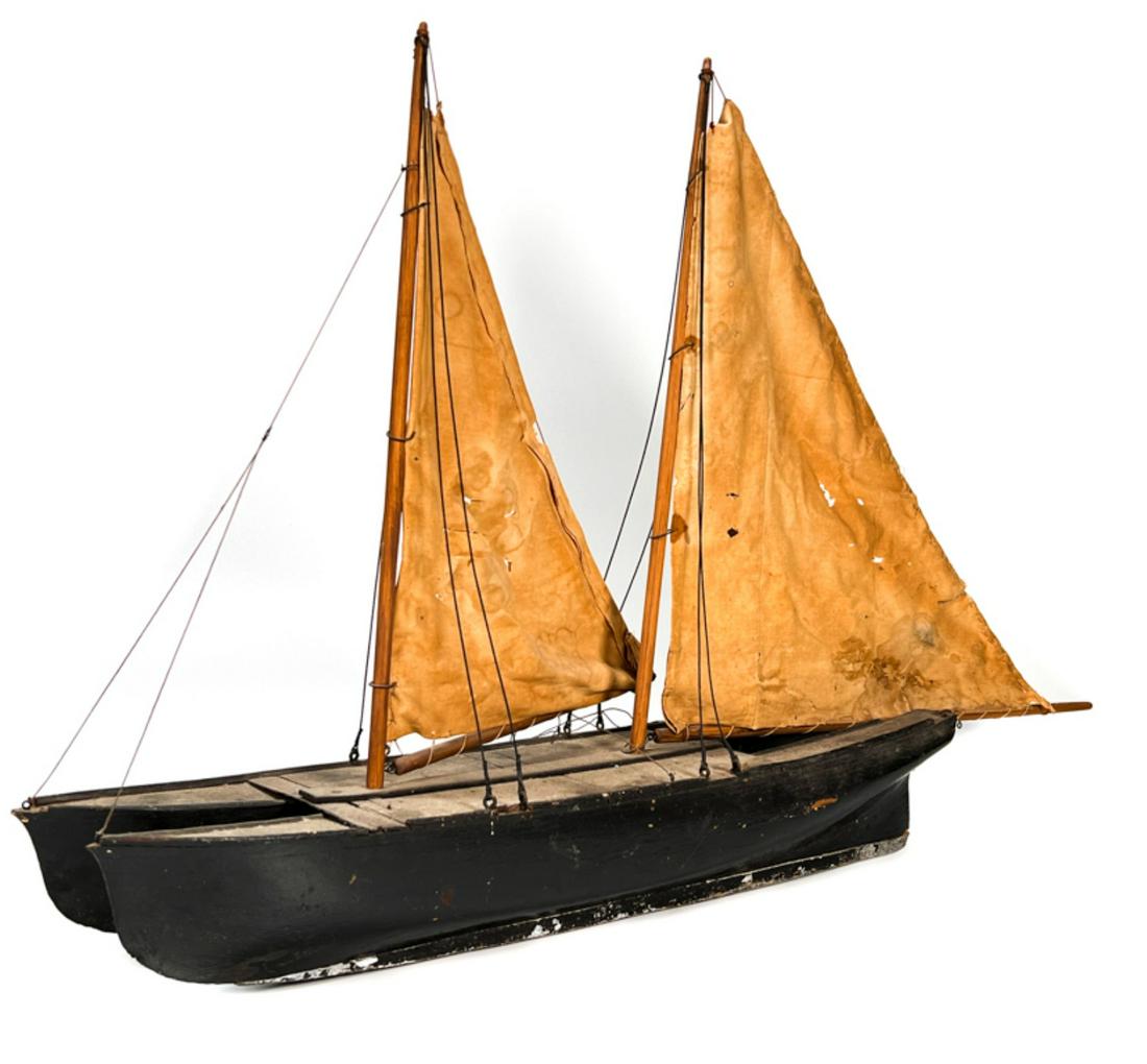 UNUSUAL (19thc) DOUBLE HULLED SAILBOAT MODEL: Painted, lead keels, rigged. Original surface. 21 x 33 inches. Condition: Sails likely replaced at a later date.