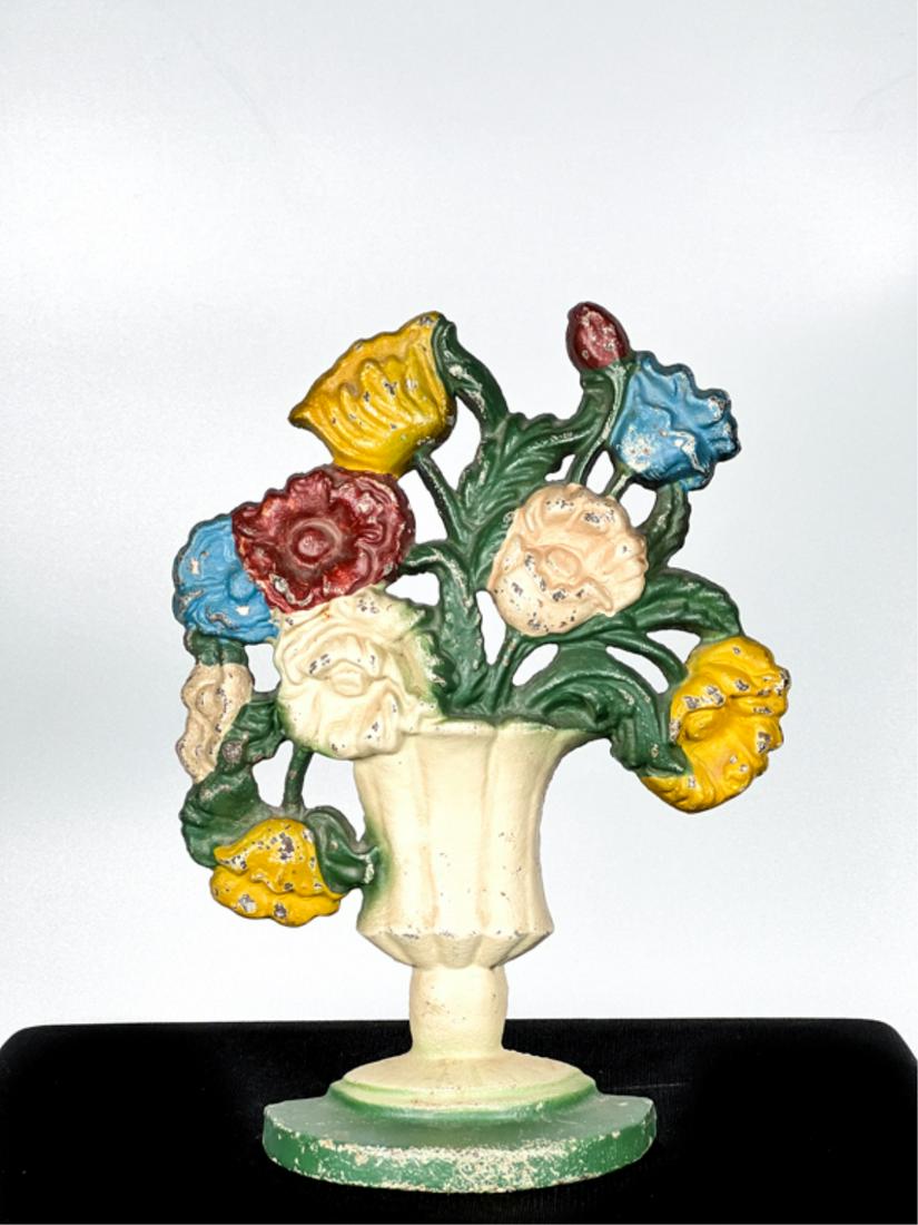 PAINTED CAST IRON WILDFLOWERS IN URN DOORSTOP: 10 x 7 1/2 inches. Condition: Good. Some wear to paint.