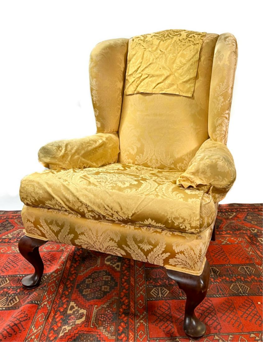 UPHOLSTERED QUEEN ANNE STYLE WINGBACK CHAIR: On cabriole legs. Condition: Wear to upholstery.