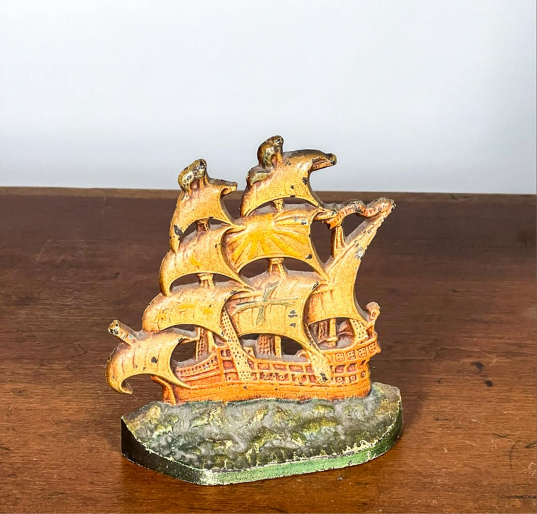 PAINTED CAST IRON "ENGLISH GALLEON" DOORSTOP: Marked verso. 5 3/4 x 5 1/8 inches. Condition: Good. Some wear to paint.