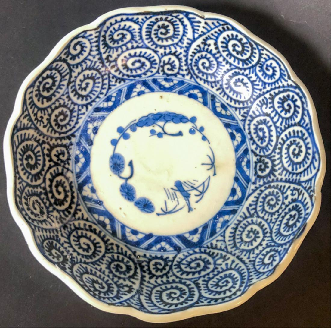 SIGNED BLUE & WHITE FOOTED CHINESE DISH: With scalloped edges. Signed in characters on bottom. Condition: Good. Expected wear. Please see photos.