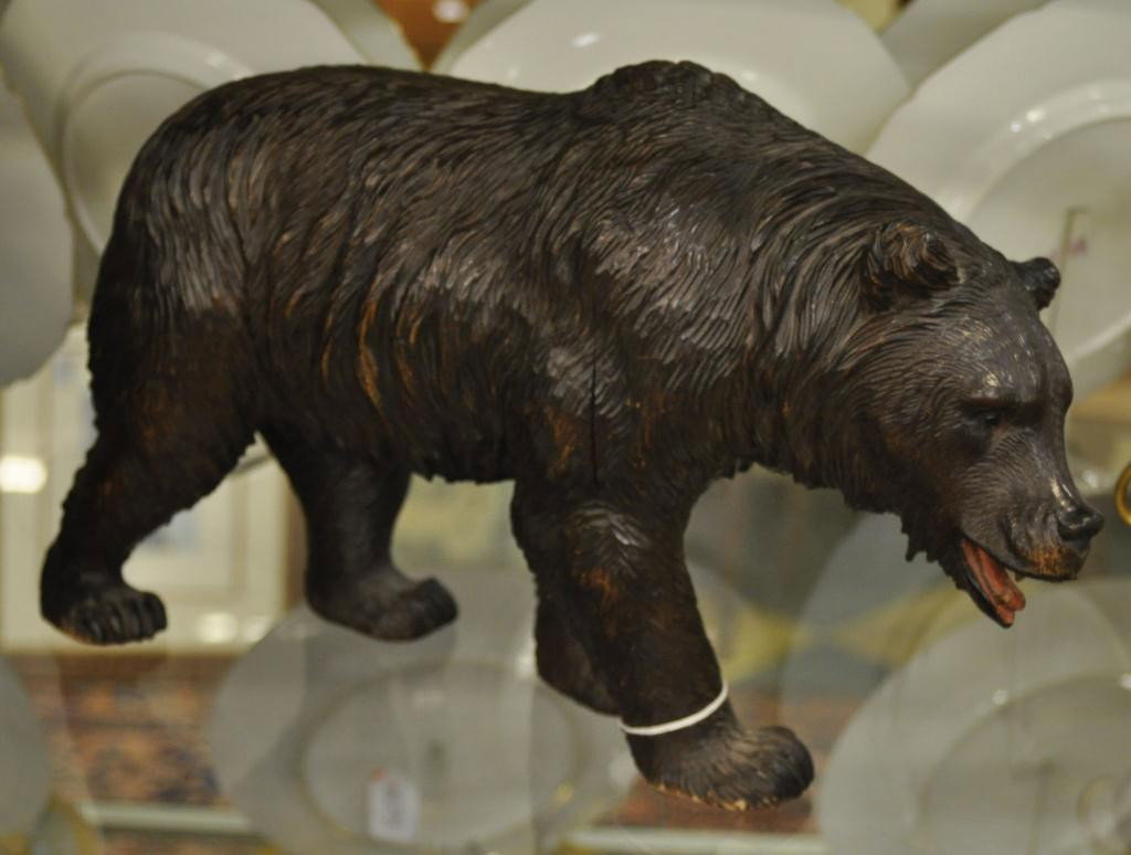 Fine carved Swiss Black Forest bear: circa 1900, with glass eyes and painted open mouth. Height: 10 1/2" Length: 18"