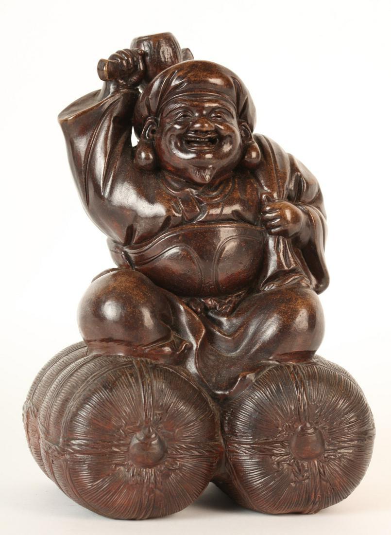 JAPANESE SCULPTED CLAY FIGURE OF DAIKOKUTEN: Brown clay with bronze-like finish. signed in (2) places. 10 x 7 x 5 1/2 inches Condition: Good Temp No 6018