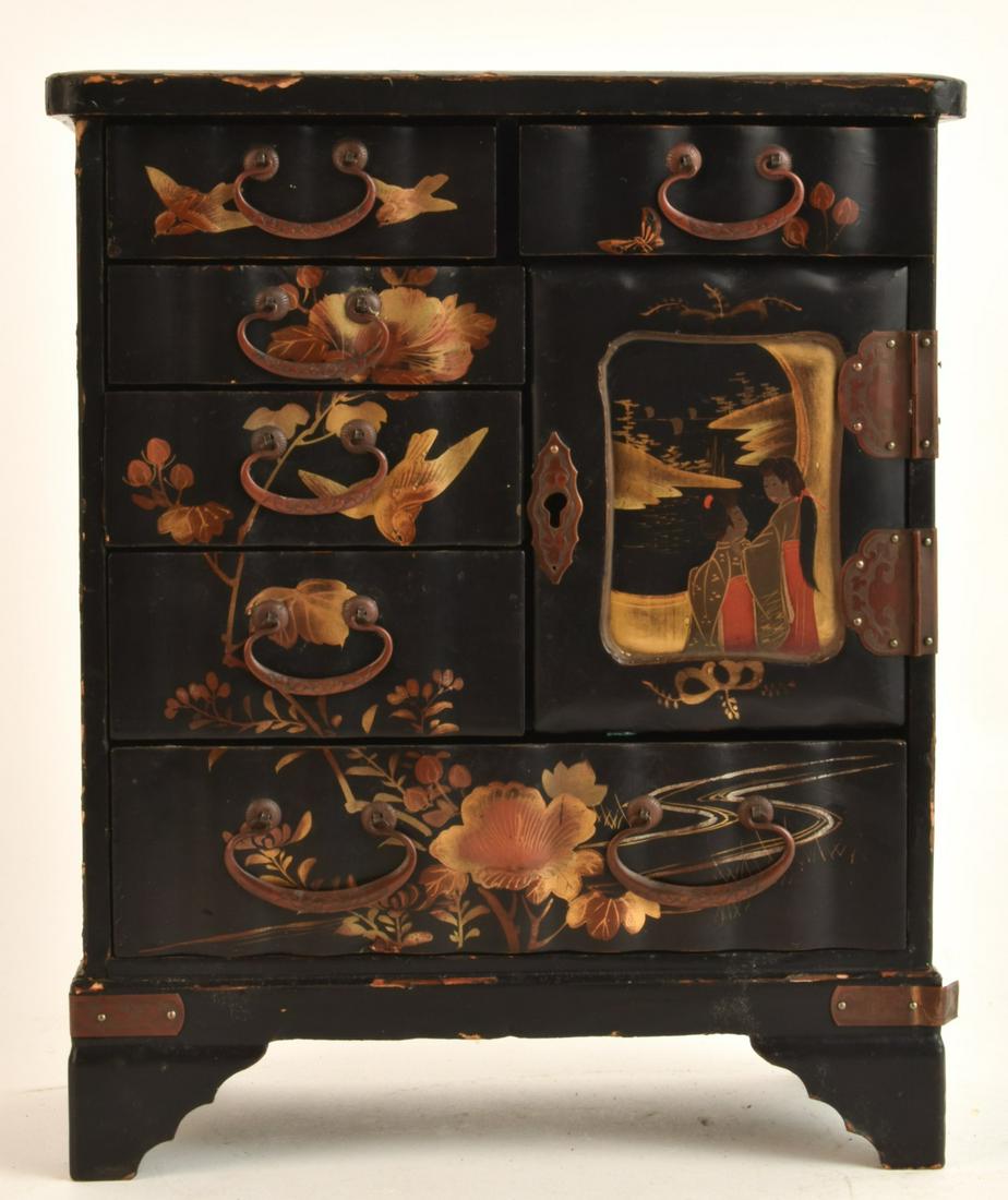 (Early 20th c) JAPANESE LACQUER JEWELRY BOX: (6) Graduating drawers with cabinet door which opens to an additional (2) drawers. 10 1/2 x 9 x 4 1/2 inches Condition: Scattered wear to lacquer, escutcheon pin absent at keyhole and lower right moun