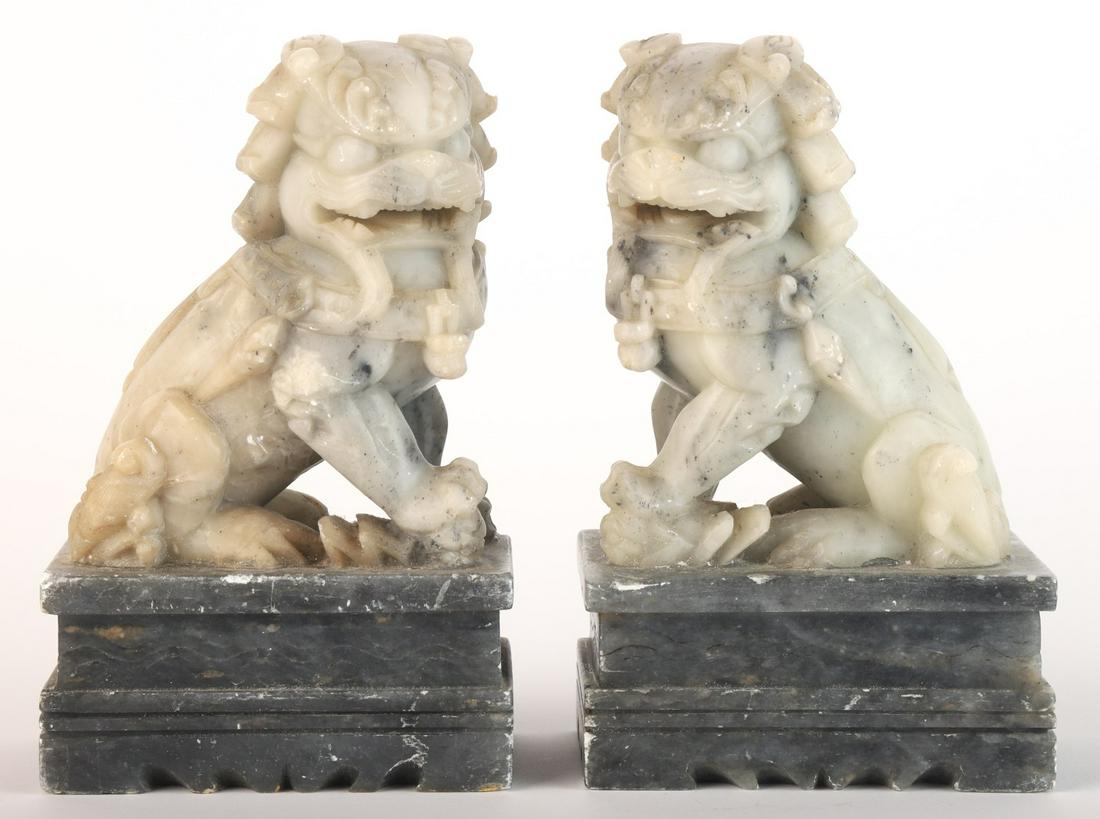 PAIR OF CHINESE CARVED AGATE GUARDIAN LIONS: Raised on carved soapstone plinths. 7 x 4 1/2 x 3 inches Condition: Minor abrasions to plinths Temp No 6002