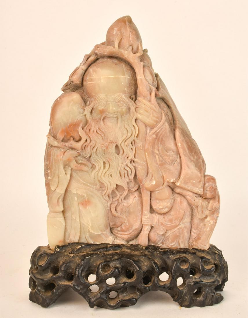 (19th c) CHINESE SOAPSTONE CARVING OF AN IMMORTAL: Raised on a custom carved and pierced stand. 9 1/2 inches (overall) Condition: Good Temp No 6585
