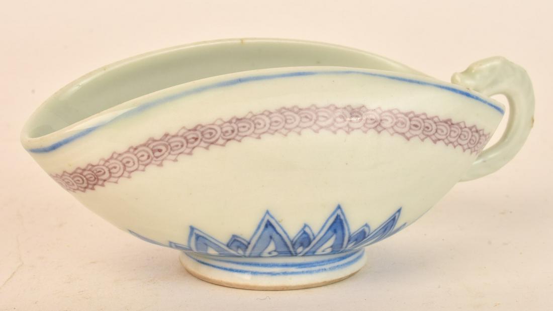 CHINESE PORCELAIN SAUCE BOAT: Figural handle and decorated with lotus blossom and geometric band. signed. 2 x 5 inches Condition: Good Temp No 6503