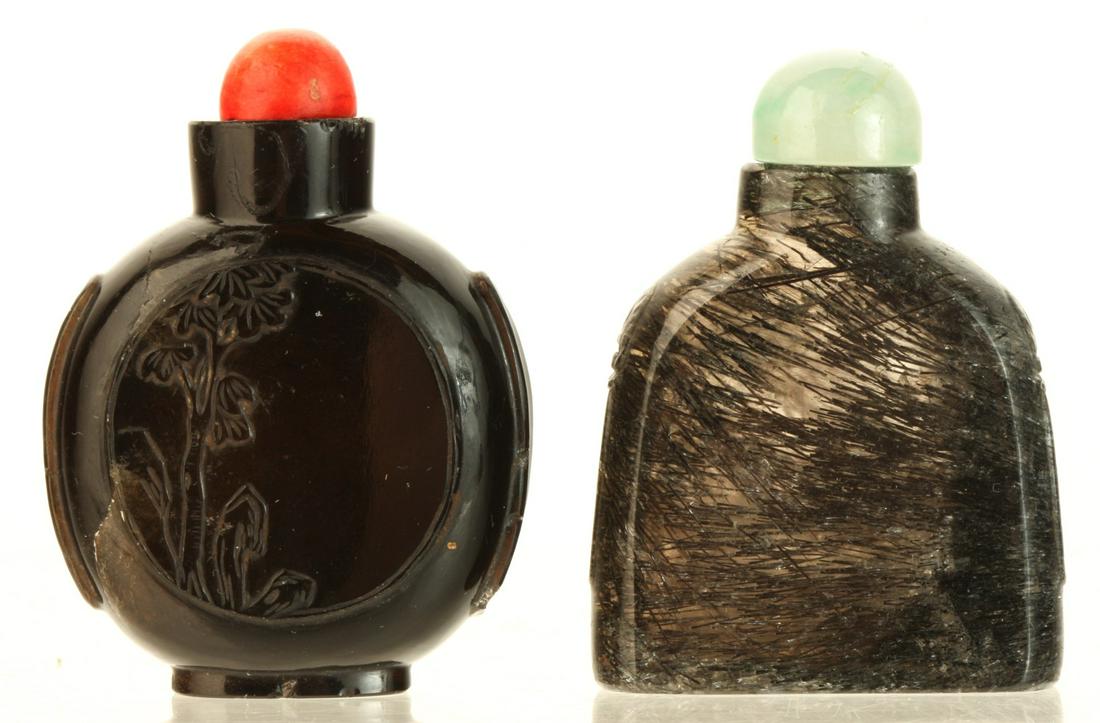 (2) INTERESTING CHINESE SNUFF BOTTLES: Probably glass with (1) carved with landscapes on each side. 2 1/4 inches. Provenance: Purchased at auction in the 1940s by the consignor's grandfather Condition: (1) absent spoon Temp No 6146