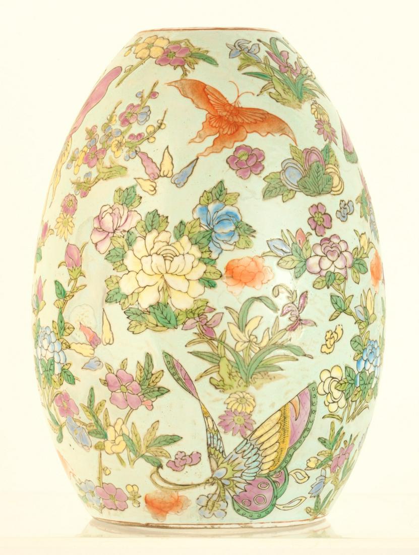 (19th c) ASIAN EGG-FORM PORCELAIN VASE: Decorated with moths, butterflies and a great variety of flora, each having incised edges. 10 1/2 x 7 inches Condition: Good Temp No 6042
