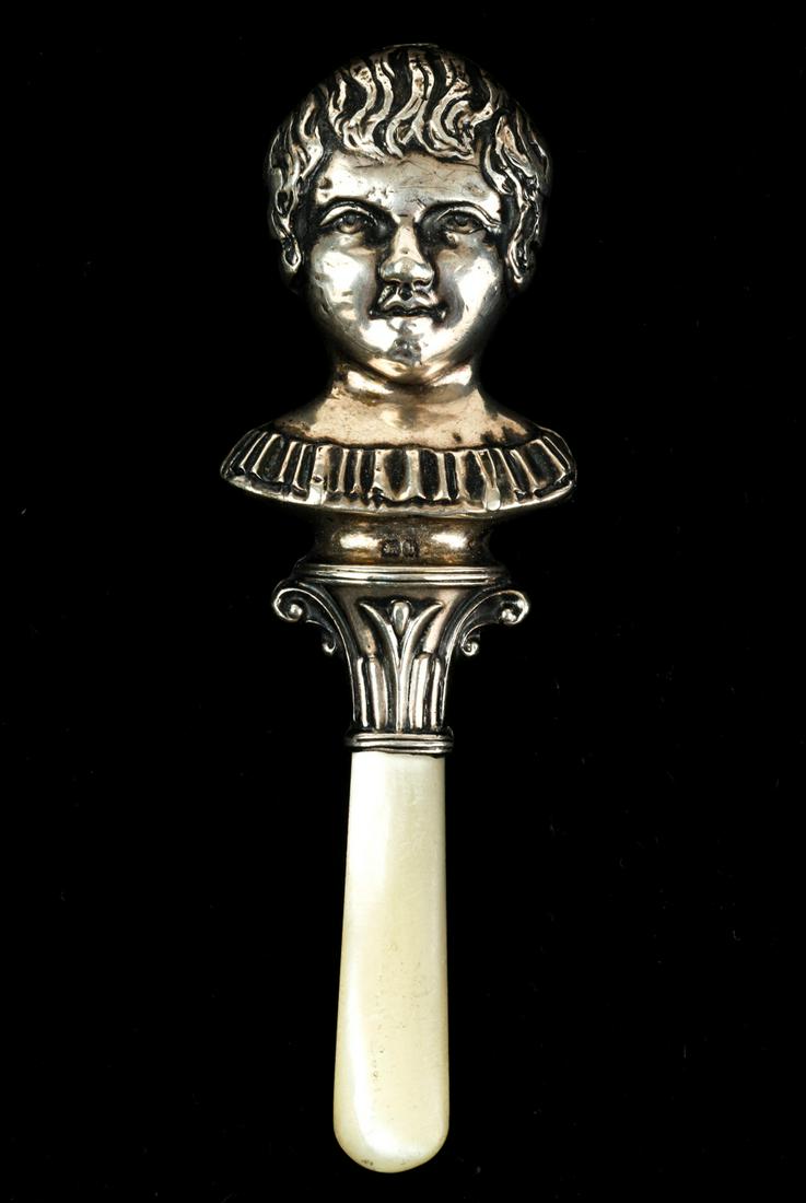 HENRY WILLIAMSON STERLING SILVER TEETHER: Young girl faces both sides. 4 1/4 inches. Condition: Good. Temp No 4703