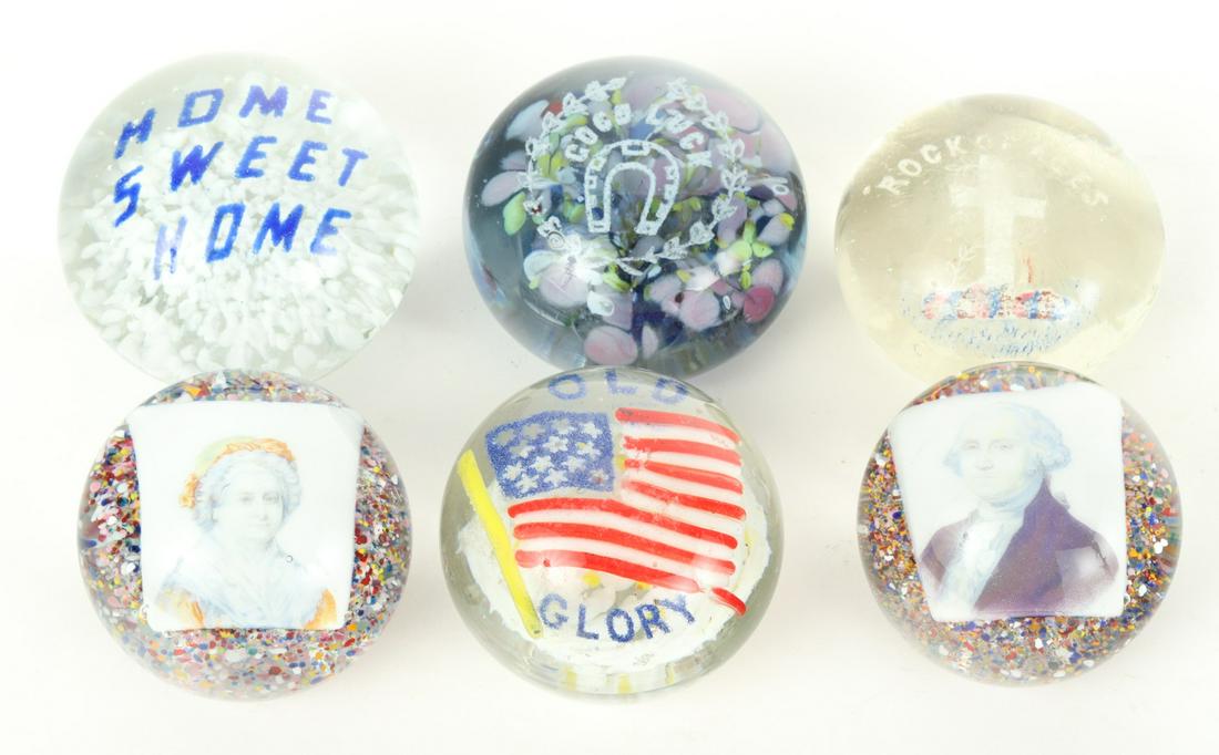 (6) GLASS PAPERWEIGHTS: Including: George and Martha Washington, Home Sweet Home, Old Glory Good Luck and Rock of Ages 2 3/8 x 3 inches.