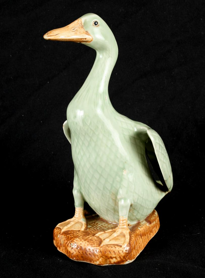 CELADON GLAZED PORCELAIN DUCK ON CARVED BASE: 11 1/2 inches excluding base.