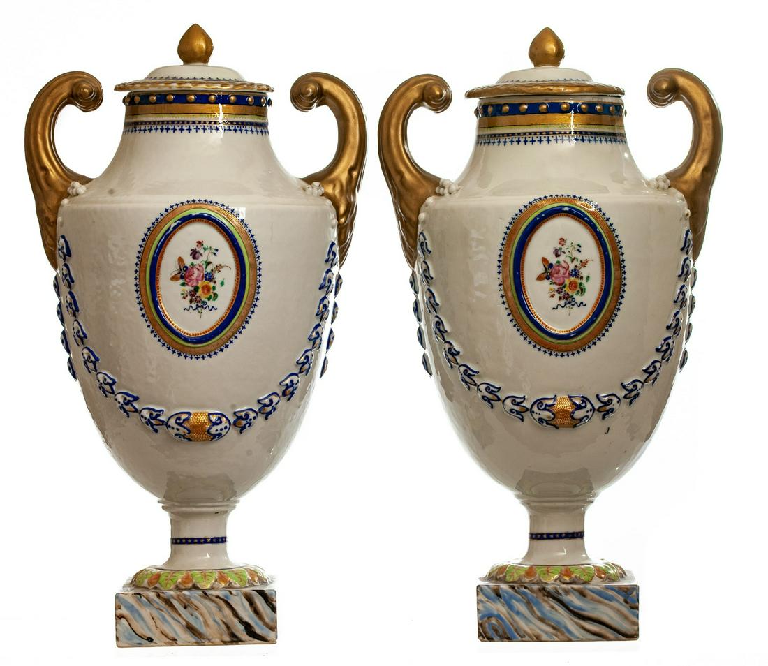 PR. FEDERAL PERIOD PISTOL HANDLE PORCELAIN URNS: "Pair of Chinese Export porcelain vases. 18th/early 19th century. Classical forms with pistol handles, molded garlands and reserves of floral sprigs in famille Rose enamels. Faux marble square bases. 
