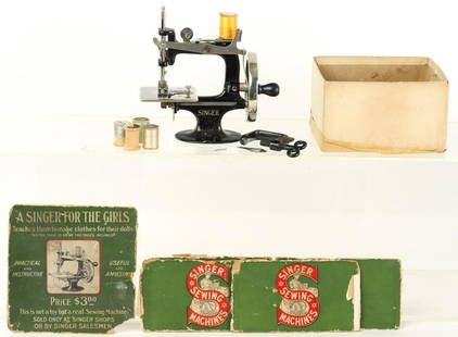 CHILDREN'S SINGER SEWING MACHINE: Hand cranked, miniature Singer sewing machine intended to teach young children how to sew. Includes (5) bobbins and a miniature C-clamp. 6 1/2 x 7 x 3 1/2 inches.