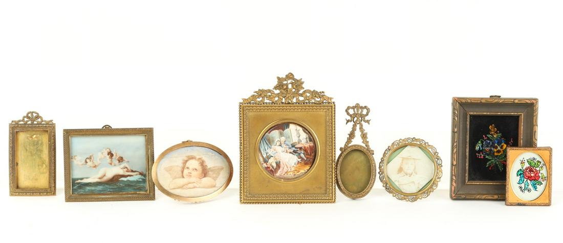 GROUPING OF MINIATURE PICTURE FRAMES etc: Bronze, brass and wooden examples including (2) tinsel paintings, (2) hand colored prints, (1) photograph and a copy of Raphael's Winged Cherub by I.H. Perry. 5 1/2 x 4 1/4 inches (and smaller)