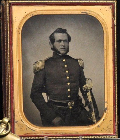 Full plate ambrotype of a Civil War Soldier: Full plate ambrotype of an unidentified Union officer bearing sword, with gilt highlights in leather case, 7 3/8" x 5 3/8" sight