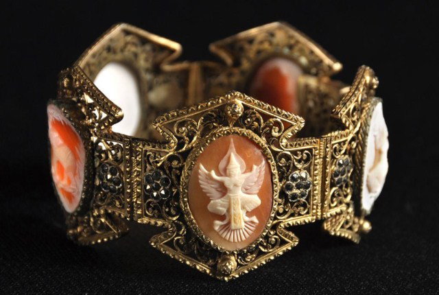 Silver gilt bracelet set with five Indian motif: Silver gilt bracelet set with 5 Indian motif shell cameos &highlighted with marcisite. 8" closed