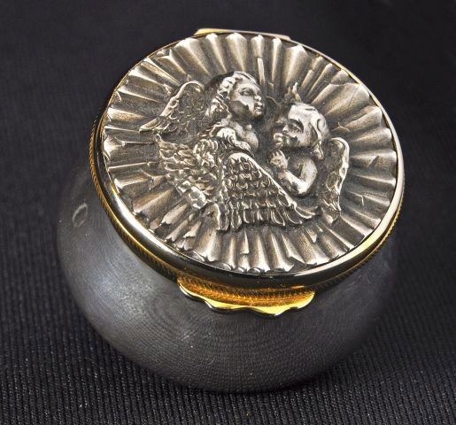 Sterling silver "Buccellati" hinge covered round: Sterling silver "Buccellati" hinge covered round box embossed angels on lid w/gilt rim, mirror inside, marked Buccellati. .925 sterling. 2.2 ozt. 1 1/4'h x 2"d