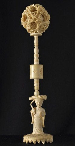 Chinese ivory multi-layer puzzle ball on stand: Chinese ivory multi-layer puzzle ball and tall figural stand. H: 10 1/2"