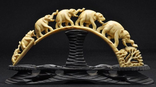 Ivory reticulated carving, 'Bridge of Elephants,' : Ivory reticulated carving, 'Bridge of Elephants,' with stained wood stand. L: 11"