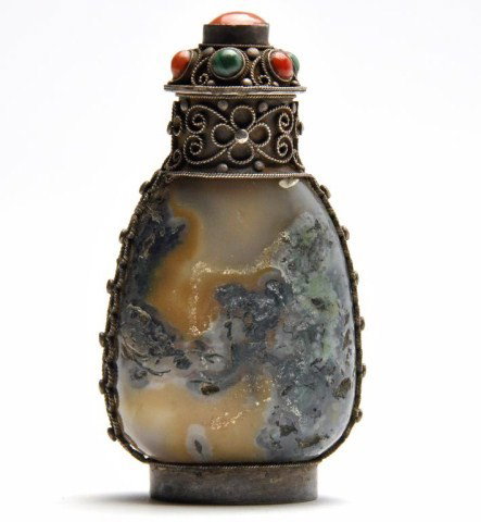 Chinese Mongolian style jade snuff bottle: Chinese Mongolian style jade snuff bottle, Qing dynasty, the mottled agate with turquoise inclusions and embellished with silver filigree fittings, matching stopper with coral and malachite inlay. H: 