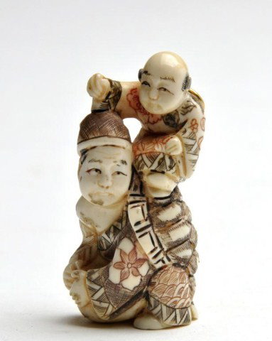 Japanese style polychrome carved ivory netsuke: Japanese style polychrome carved ivory netsuke, Hong Kong, of a man astride another man with turtle shell, signed. H: 2"