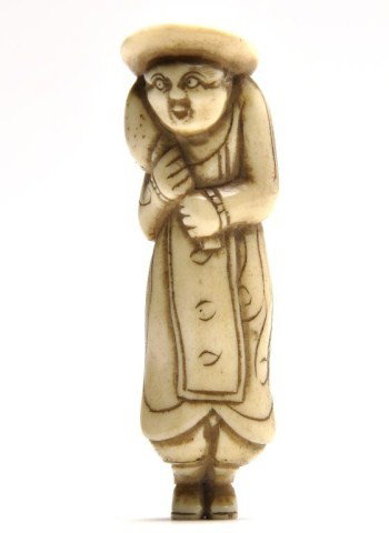 Japanese stag antler figural netsuke, 19th century: Japanese stag antler figural netsuke, 19th century, carved as a foreigner holding a rooster, stained details. H: 2 3/4"