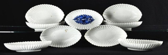 Lot of nine boat form Asian bowls: Lot of nine boat form Asian bowls with scalloped rim, one blue and white decorated, the other eight blanc de chine, 9"l