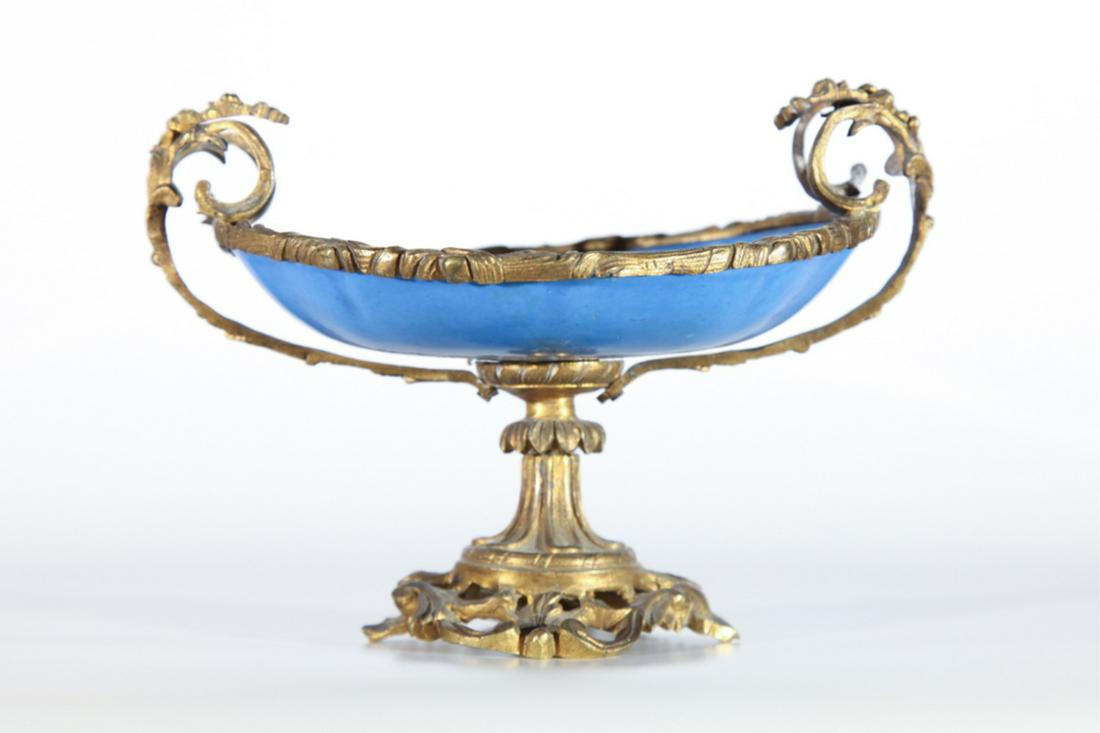 (19th c) PORCELAIN TAZZA with ORMOLU MOUNTS: Dish hand painted with a floral motif framed with a gold floral filigree. 5 1/2 x 7 x 5 1/2 inches