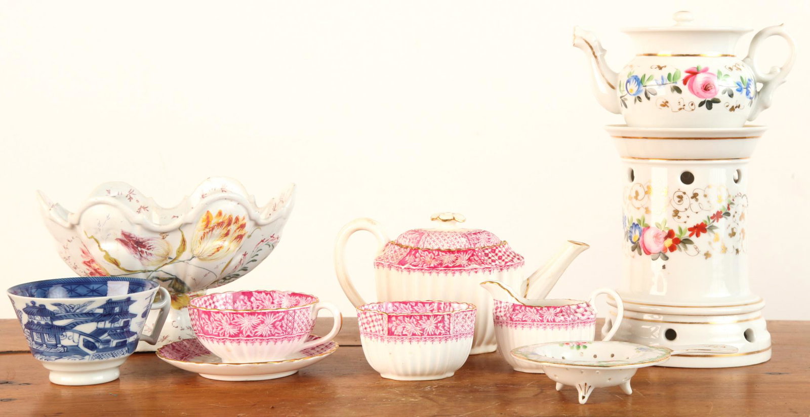 INTERESTING GROUPING OF BONE CHINA, DELFT etc: Including: Miniature Spode (4) piece tea set with 4 inch teapot. (18th c) Raised Delft bowl with shaped rim signed with a star, (3) Part French porcelain tea warmer 9 1/2 inches, tea strainer and a Ca
