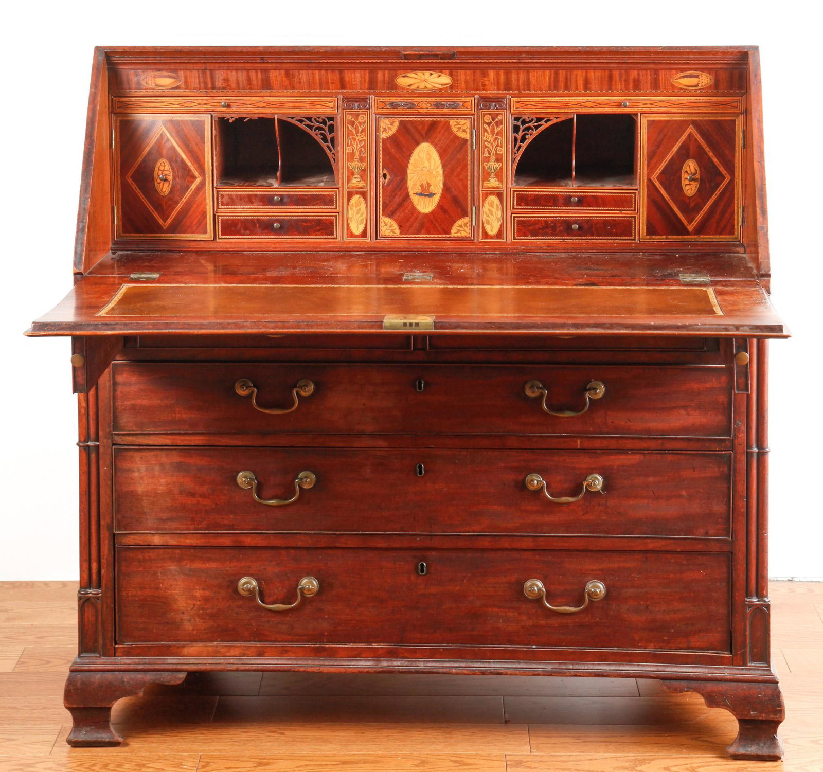 (18th c) ENGLISH ADAMS MAHOGANY SLANT FROM DESK: Carved and banded lid opens to an impressive interior of marquetry inlaid drawers, door and pigeon holes over graduating drawers flanked by compound pier columns. All raised on an applied molded base 