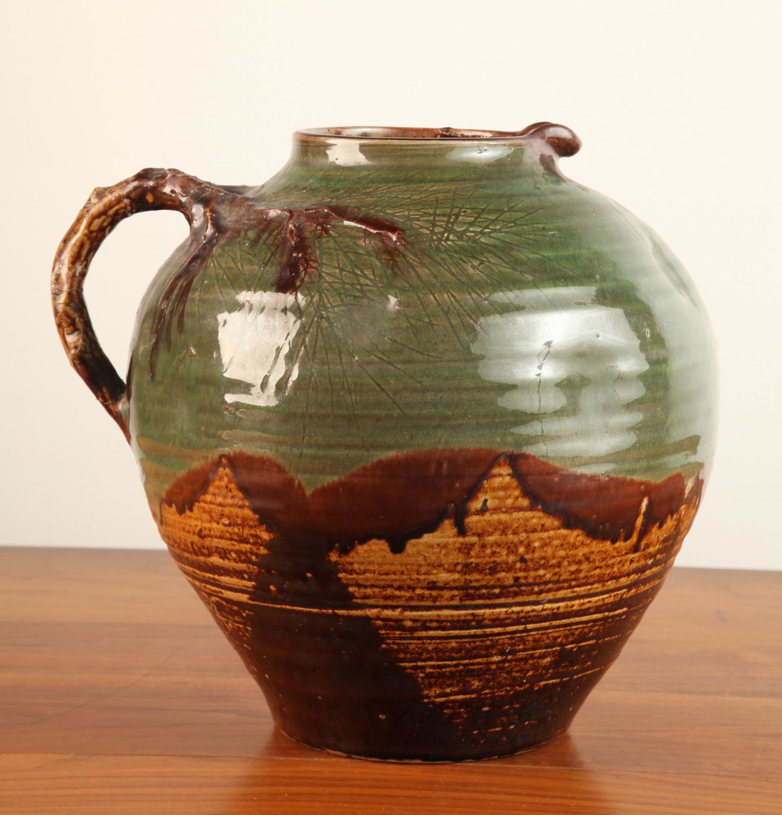 LARGE BULBOUS JUG with WHITE PINE MOTIF: Branch-form handle. Two color glazed and inscribed stoneware. 12 x 13 inches