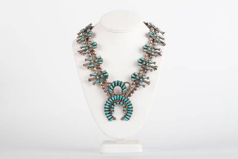 ZUNI TURQUOISE & SILVER SQUASH BLOSSOM NECKLACE: 5.84 troy ounces. Pendent 3 x 2 1/4 inches, 30 inches (overall length)