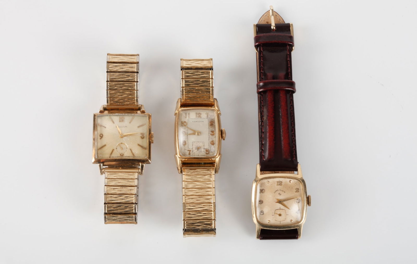 (3) BULOVA, LORD ELGIN & HAMILTON WRIST WATCHES: Each gold filled.