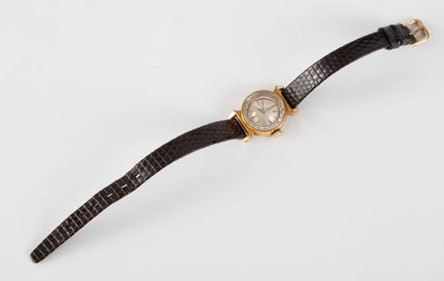 VINTAGE LADIES OMEGA WRIST WATCH: Gold toned 12mm case. Silver dial with gold markers and brown leather band.